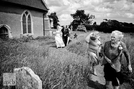 A windy arrival for the bride at her Suffolk country church