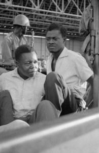 Original caption: 12/2/1960- Leopoldville, Congo- Former Prime Minister Patrice Lumumba, (right), his hands tied behind his back and without his glasses, is taken to jail after his arrest and return to Leopoldville. Troops of Colonel Mobutu seized Lumumba at the Port of Francqui. Another prisoner, Joseph Okito, former vice president of the Senate, is on the left. Image by © Bettmann/CORBIS