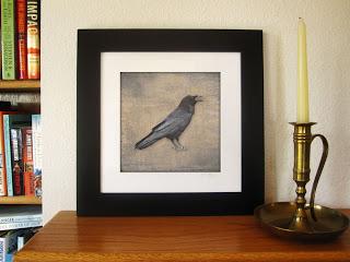 Framed raven print, a solitary raven with each feather in exquisite detail is printed on a background texture with the look of old linen.