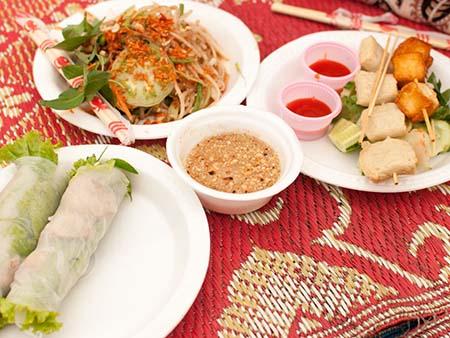 An assortment of Cambodian foods, rice paper rolls and papaya salad