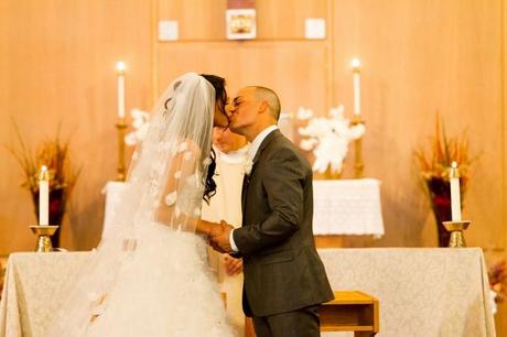 couple kissing at altar