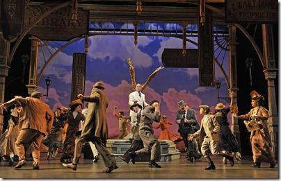 The residents of River City, Iowa fall under the spell of charismatic traveling salesman Harold Hill (Stef Tovar, center) in Paramount Theatre’s production of The Music Man, directed by Rachel Rockwell.  (photo credit: Liz Lauren)