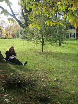 This is me, Julie Jordan Scott, writing in my notebook on the lawn of the house where Emily lived in Amherst, Massachusetts
