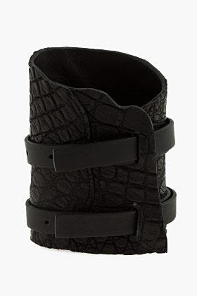 Balmain Black croco-embossed Buckle cuff ($900) available at...
