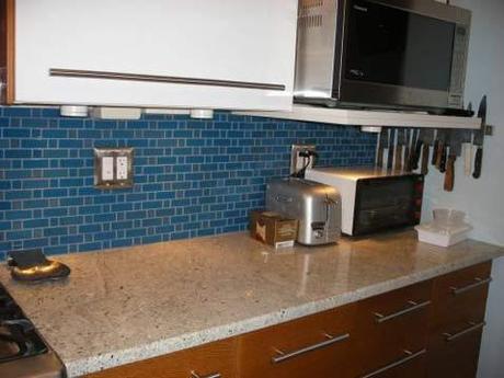 Knotty pine cabinets + neutral counters + blue backsplash