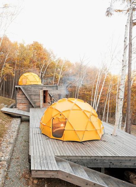 Yellow North Face tent atop a wooden deck