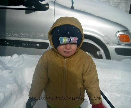 My baby girl standing in front of the snow. Almost as tall as her.