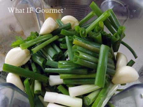 Scallions, garlic, cilantro, Italian flat-leaf parsley, and thyme waiting to be pureed into green seasoning.