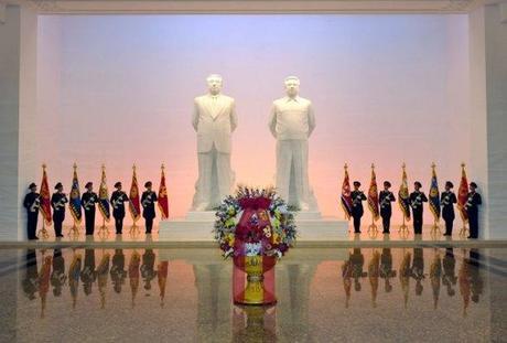 A floral basket from Kim Jong Un in front of statues of his grandfather Kim Il Sung and father Kim Jong Il at Ku'msusan in Pyongyang on 16 February 2013 (Photo: Rodong Sinmun)