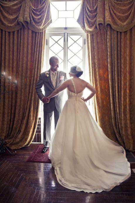 bride and groom in front of classic window