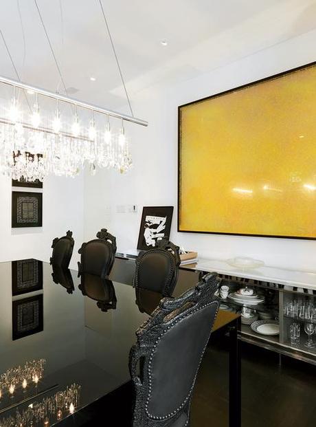 Modern dining room with black furniture and Cellula chandelier