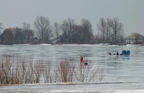 Ice fishermen heads out on ice - Frenchman's Bay - Ontario - Canada