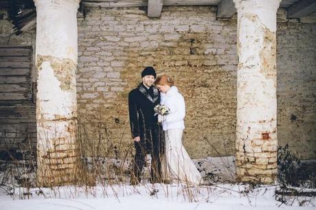 wedding photography in snow in front of brick wall