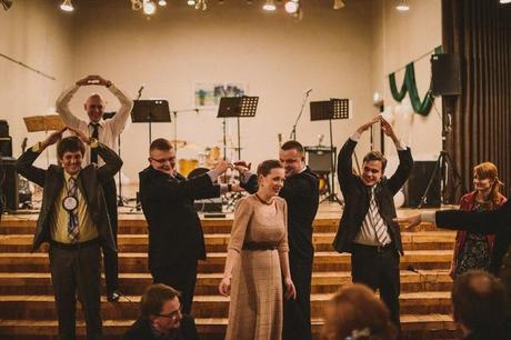 guests dance in church at wedding