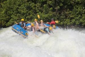 White-water rafting on the Nile river in Uganda - ‘Superwoman’ exit from raft going over ‘Vengeance’