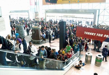 big crowd of people arriving for and riding elevators to 2012 New York Comic Con comics and pop culture convention