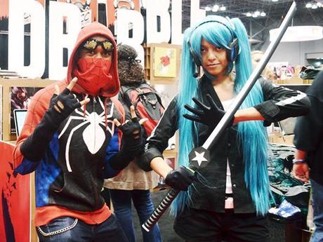 couple wearing Spiderman and ninja manga superhero costumes and posing in front of RedBubble booth at 2012 New York Comic Con comics and pop culture convention