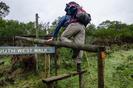 climbing over fence via stile