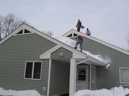 Shoveling snow off roof