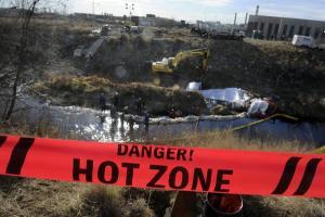 Workers contracted by Suncor use vacuum trucks and absorbent material to suck up water mixed with an unidentified liquid leaking into Sand Creek north of downtown Denver on Nov. 30, 2011  Read more: Toxics from Suncor refinery spill still seeping into water; Colorado vows to 