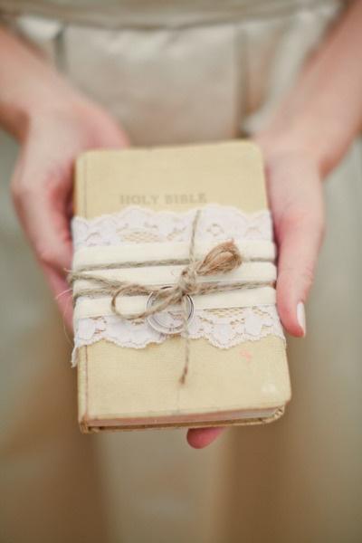 Lace-wrapped Bible as ring holder.