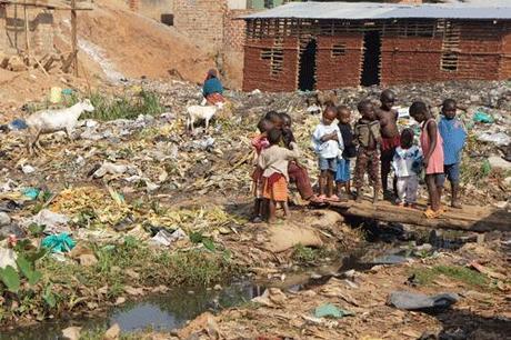 Children playing in rubbish in Namuwongo slums