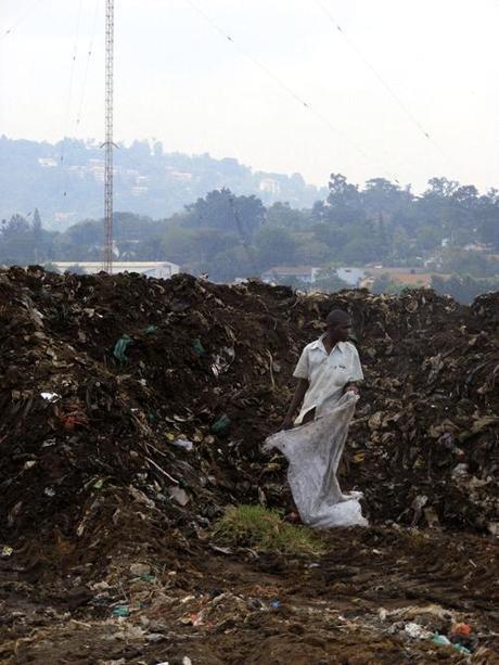 Man sorting rubbish Namuwongo Kampala slums