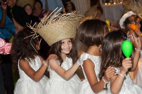 kids in straw hats dance at wedding