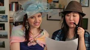 Lizzie and Charlotte use costume theater to portray a conversation between Mrs Bennet and Mr Bennet.