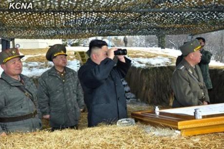 Kim Jong Un (3rd L) observes anti-aircraft drills through binoculars.  Also seen in attendance are VMar Choe Ryong Hae (2nd L) and Gen. Ri Pyong Chol (R) (Photo: KCNA)