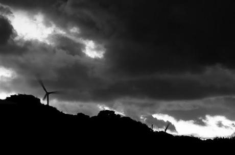 dark clouds over wind turbines