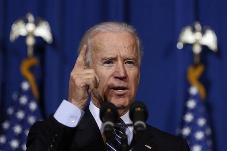 U.S. Vice President Joseph Biden talks before U.S. President Barack Obama signs the Violence Against Women Act while at the Department of Interior in Washington, March 7, 2013. REUTERS/Larry Downing