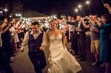 sparklers as couple leaves wedding