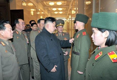 Kim Jong Un (C) inspects a the color of an overcoat, part of the uniform for the student body of the Mangyo'ngdae and Kang Pak Sok Revolutionary Schools in Pyongyang on 24 March 2013.  Also seen in attendance are VMar Choe Ryong Hae (L) and Gen. Kim Kyok Sik (2nd L) (Photo: Rodong Sinmun)