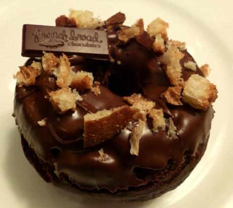 Paris of the South, a chocolate cake doughnut with a chocolate ganache topping, topped with buttery-toasted City Bakery baguette and a piece of French Broad Chocolate with a hint of coffee.