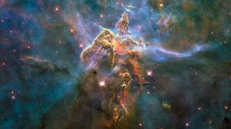 A mountain of gas and dust rises in the Carina Nebula photography. Picture taken with Hubble Telescope 