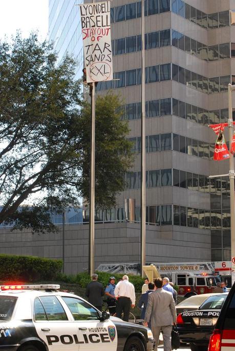 Activist Climbs Flagpole Outside LyondellBasell, Hangs Banner Denouncing Investment in Tar Sands