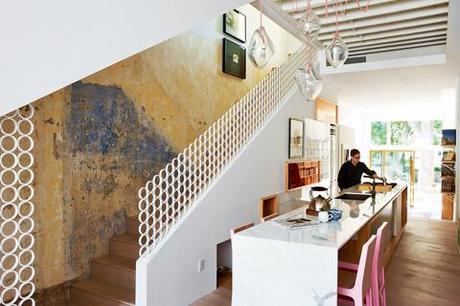 Modern kitchen with marble countertop and pink dining chairs