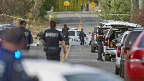 Pierce County sheriff's deputies secure a scene on 54th Avenue Northeast in the Fife Heights neighborhood in Tacoma, Wash., where shots were fired Tuesday, March 26, 2013. Police said that the shooter is holed up in a house.