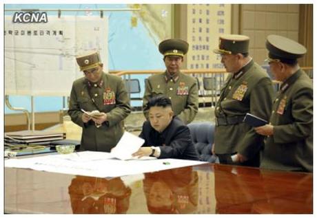 Kim Jong Un (seated) reviews military operations plans during a meeting held after midnight on 29 March 2013 (Photo: KCNA)