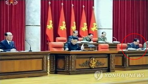 Kim Jong Un (C) reads through the meeting documents of the Korean Workers Party Central Committee plenary meeting on 31 March 2013.  Also seen in the front row are SPA Presidium President Kim Yong Nam (L) and (highlighted) NDC Vice Chairman and KWP Administration Director Jang Song Taek (R) (Photo: KCTV-Yonhap)