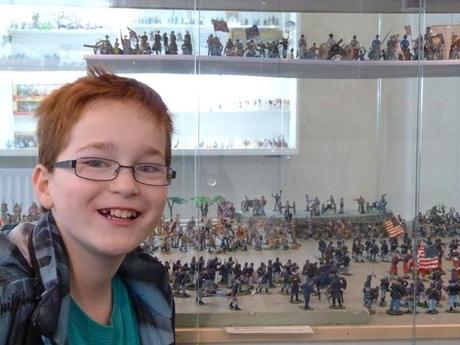 boy with toy soldier display