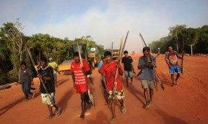 Brazil dam row – local activists march past machinery being used in the construction of the massive Belo Monte hydroelectric dam. Photograph: Reuters