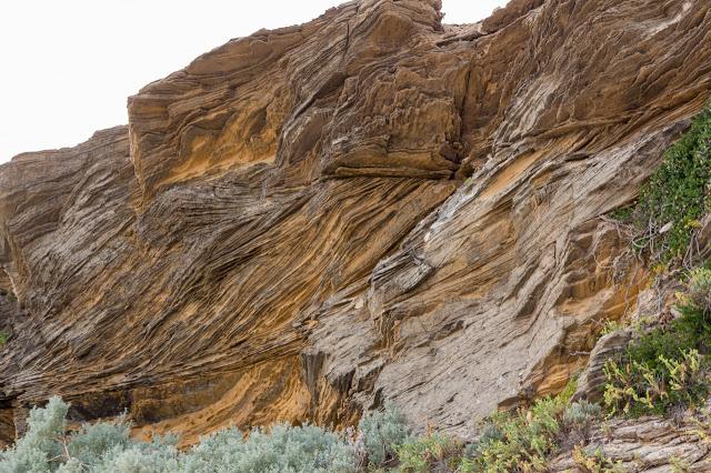 jagged layers of rock on cliff face