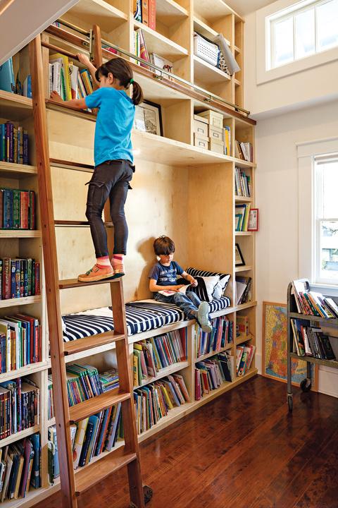 Modern double-height library room renovation with rolling ladder