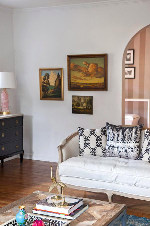 Design Manifest living room, settee, Kelly Wearstler pillows, vintage paintings