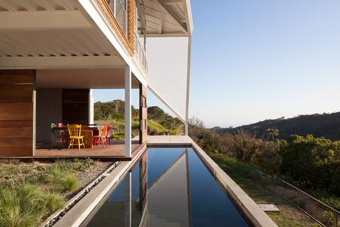 reflecting pool in modern house in el salvador with creative roofing