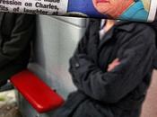 Commuter Juxtaposes Newspaper Unsuspecting Travelers
