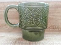 green mug with a butterfly design