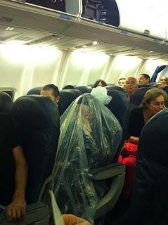 background on the picture of the guy on a plane in a plastic bag